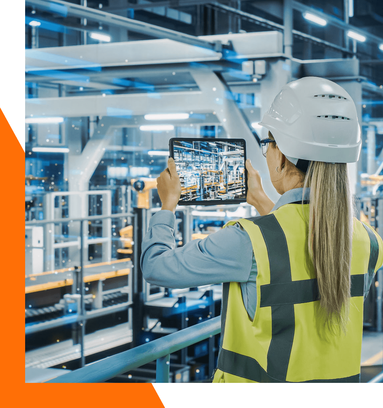 Worker using tablet in modern industrial facility.