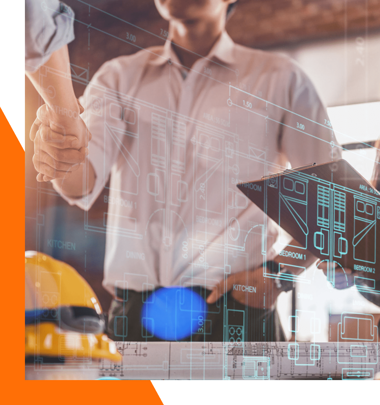 Architects shaking hands over construction plans.